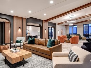 Bar Lounge area with bench and chair seating and large wood like doors and cabinets with green tile back splash